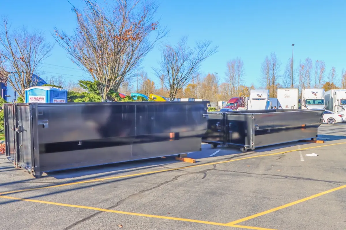 Professional dumpster rental service with roll-off container on residential driveway in Hillview